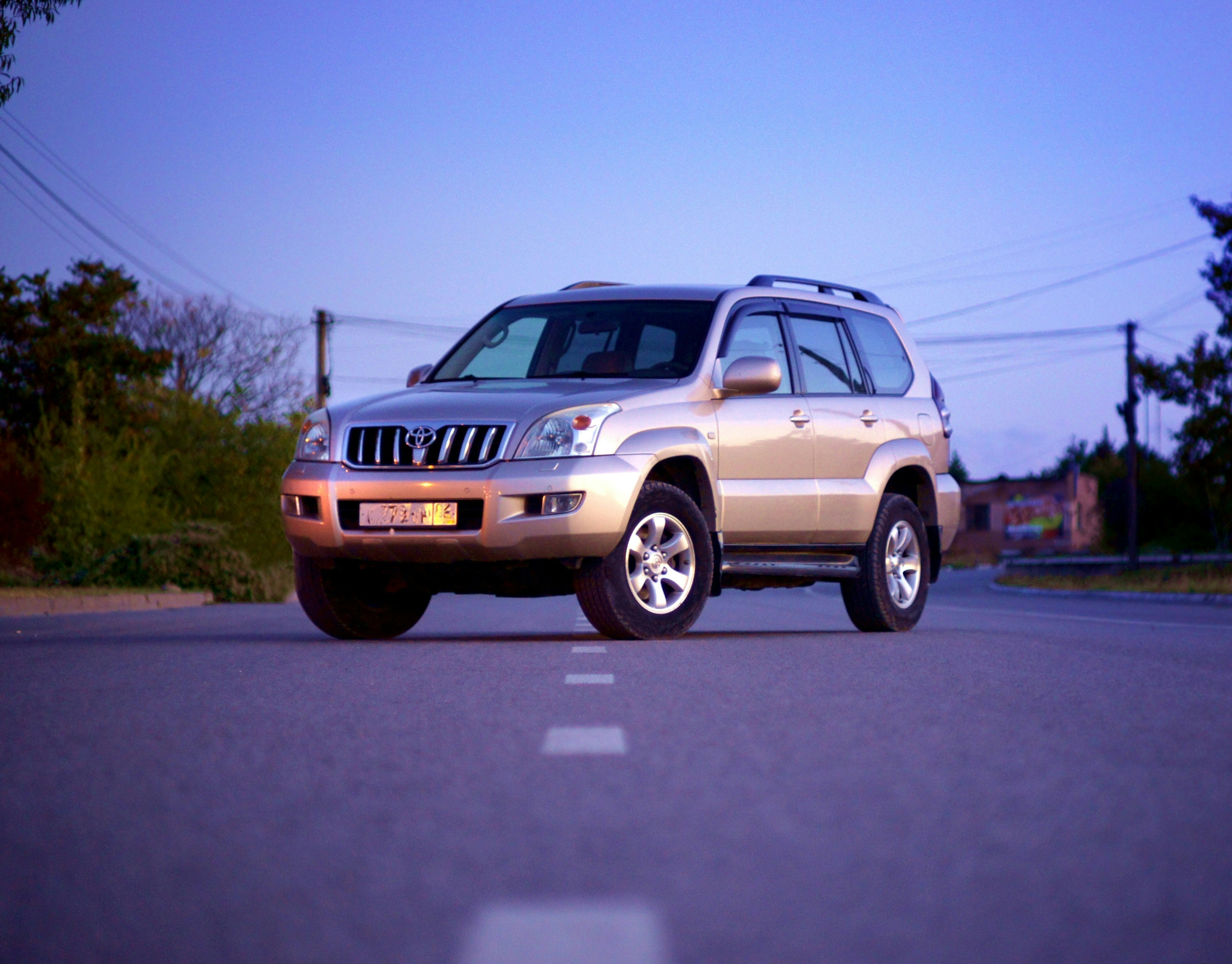 Prado SUV travelling on a paved road